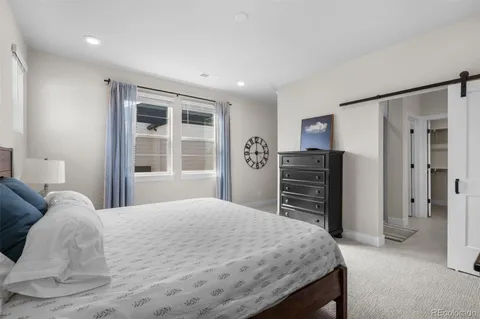 a bedroom with a bed closet and a window