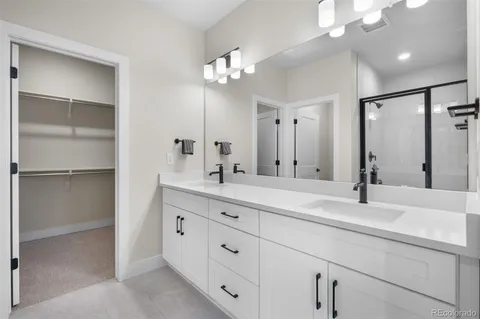 a bathroom with a double vanity sink and a mirror