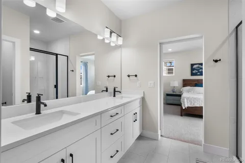 a en suite bathroom with double sink and a mirror