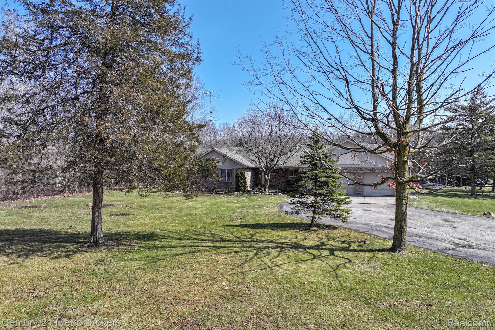5464 North Seymour Road Flushing, MI 48433 - Photo 8 of 59 View of front of house with a front lawn, driveway, and an attached garage