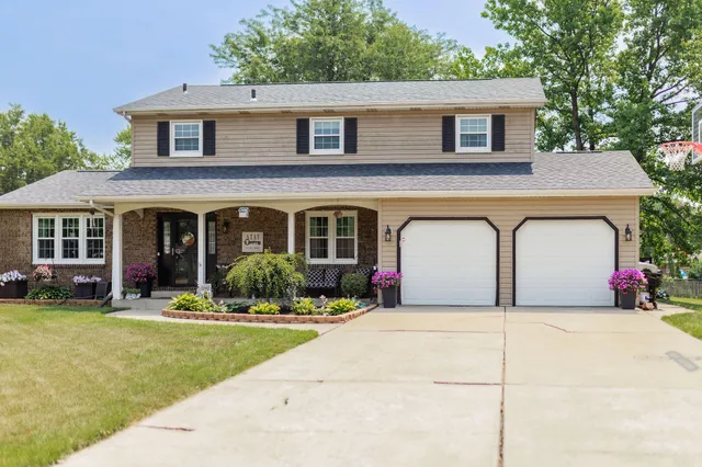 a front view of a house with yard and porch