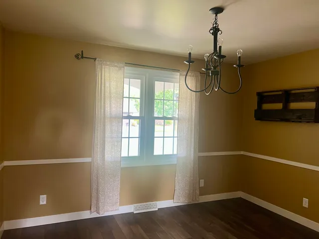 a front view of a house with swimming pool having outdoor seating