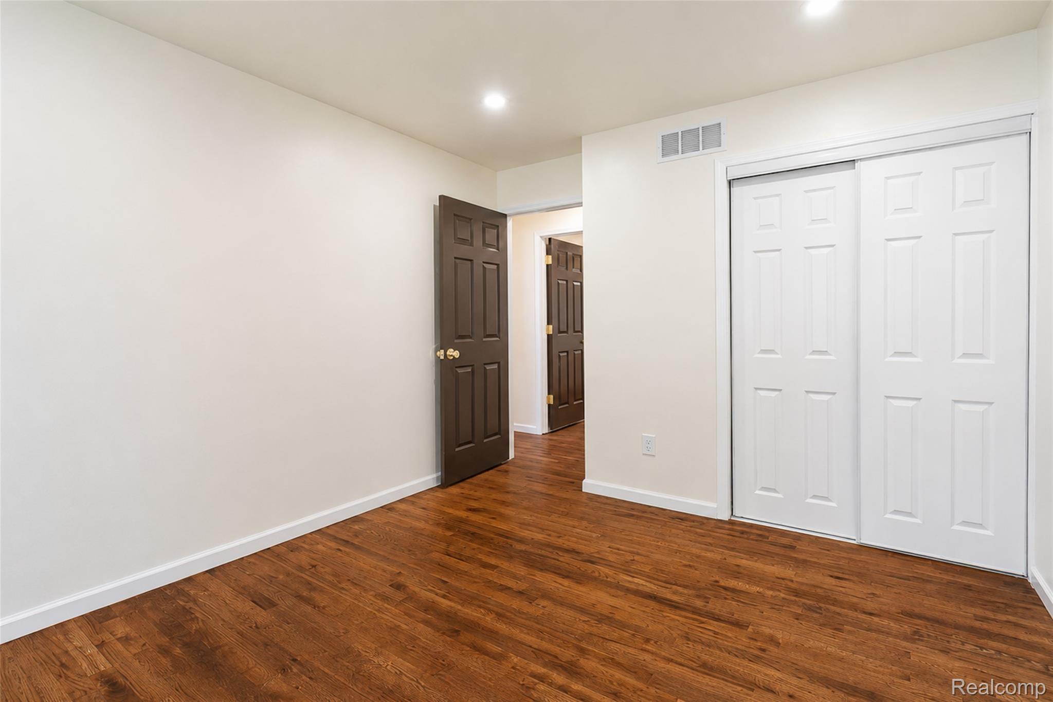 201 Cardwell Street Inkster, MI 48141 - Photo 25 of 41 Bright room featuring wood-finish flooring, white baseboards, and a neutral wall color