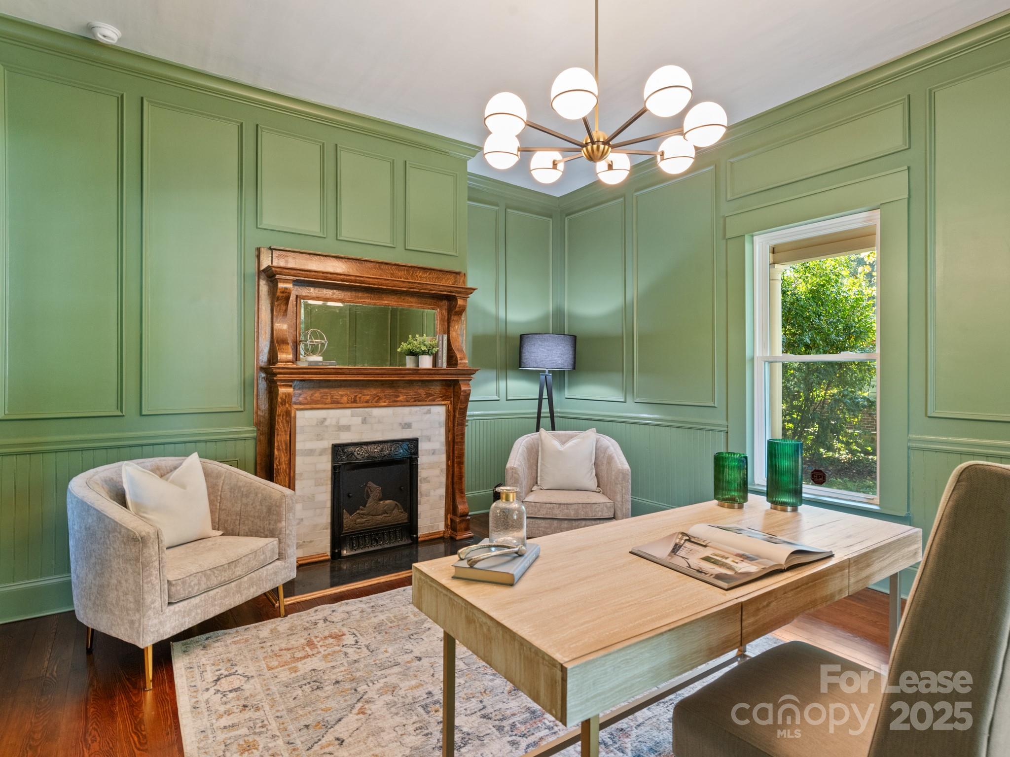 402 South Chester Street Gastonia, NC 28052 - Photo 13 of 48 a living room with furniture a fireplace and a large window