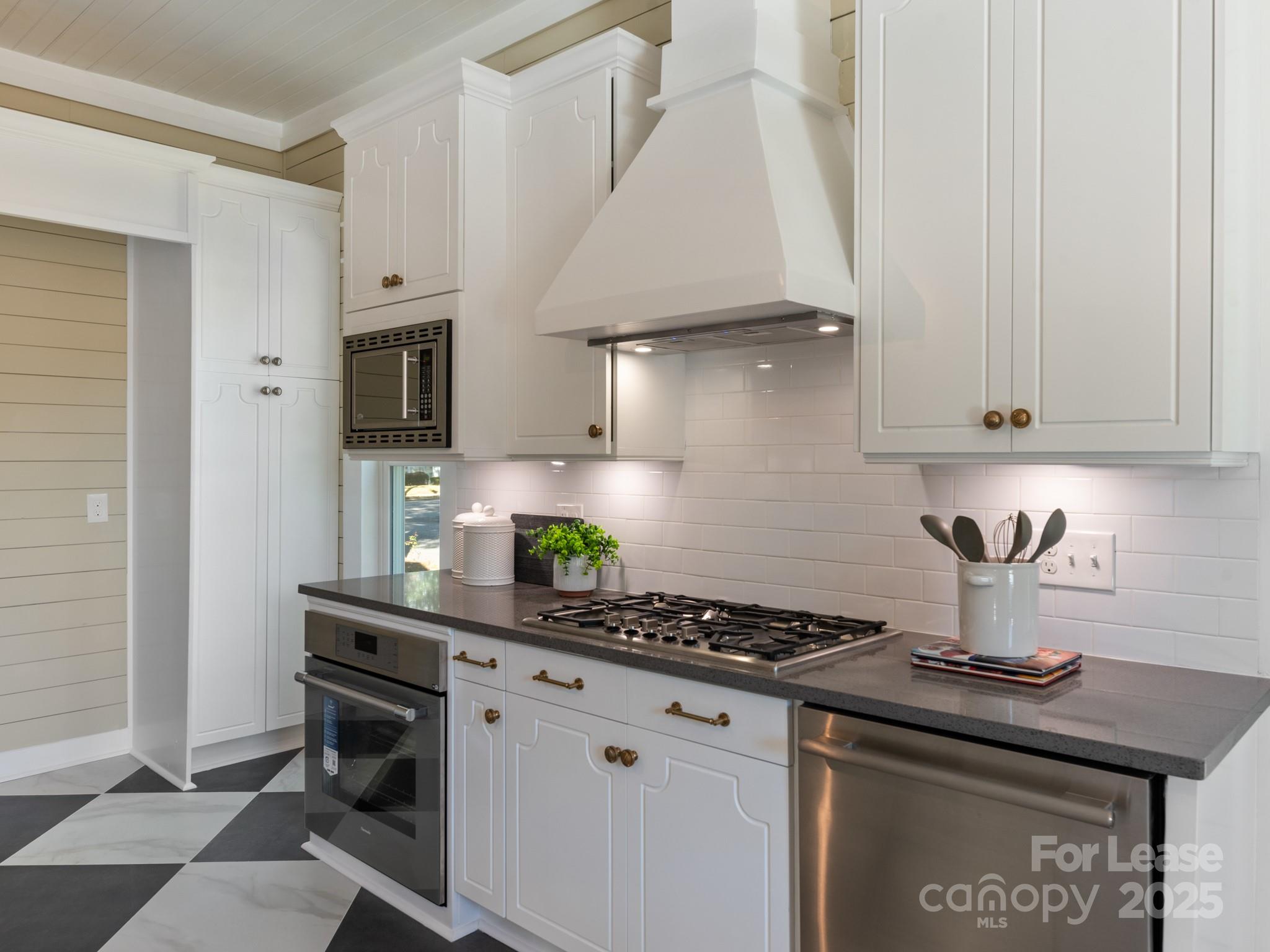 402 South Chester Street Gastonia, NC 28052 - Photo 24 of 48 a kitchen with stainless steel appliances a sink a stove and cabinets