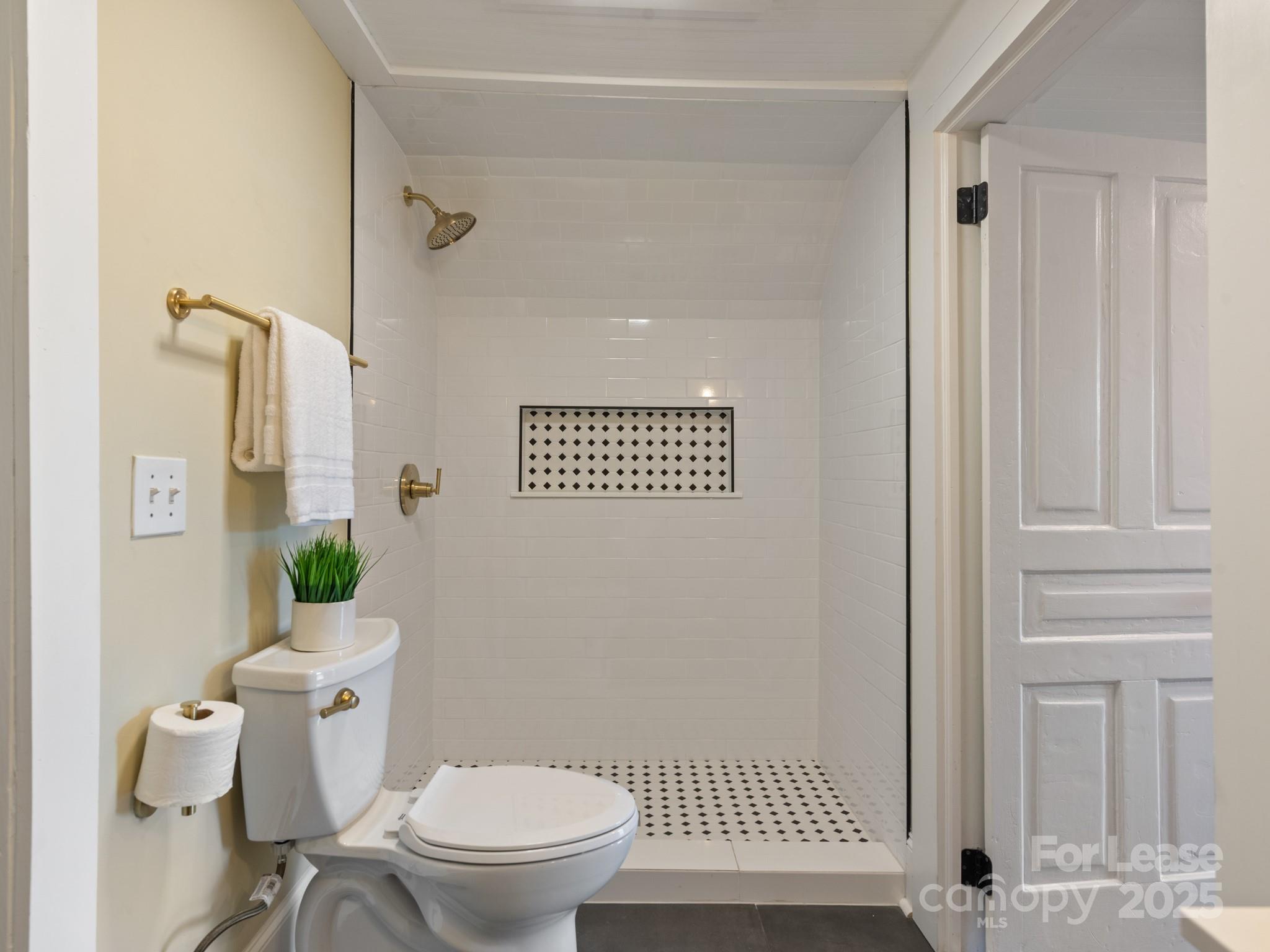 402 South Chester Street Gastonia, NC 28052 - Photo 36 of 48 a white toilet sitting next to a bathroom sink