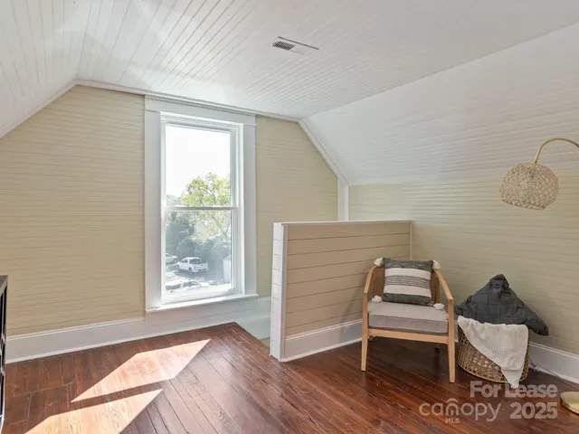 a view of room with stairs and wooden floor