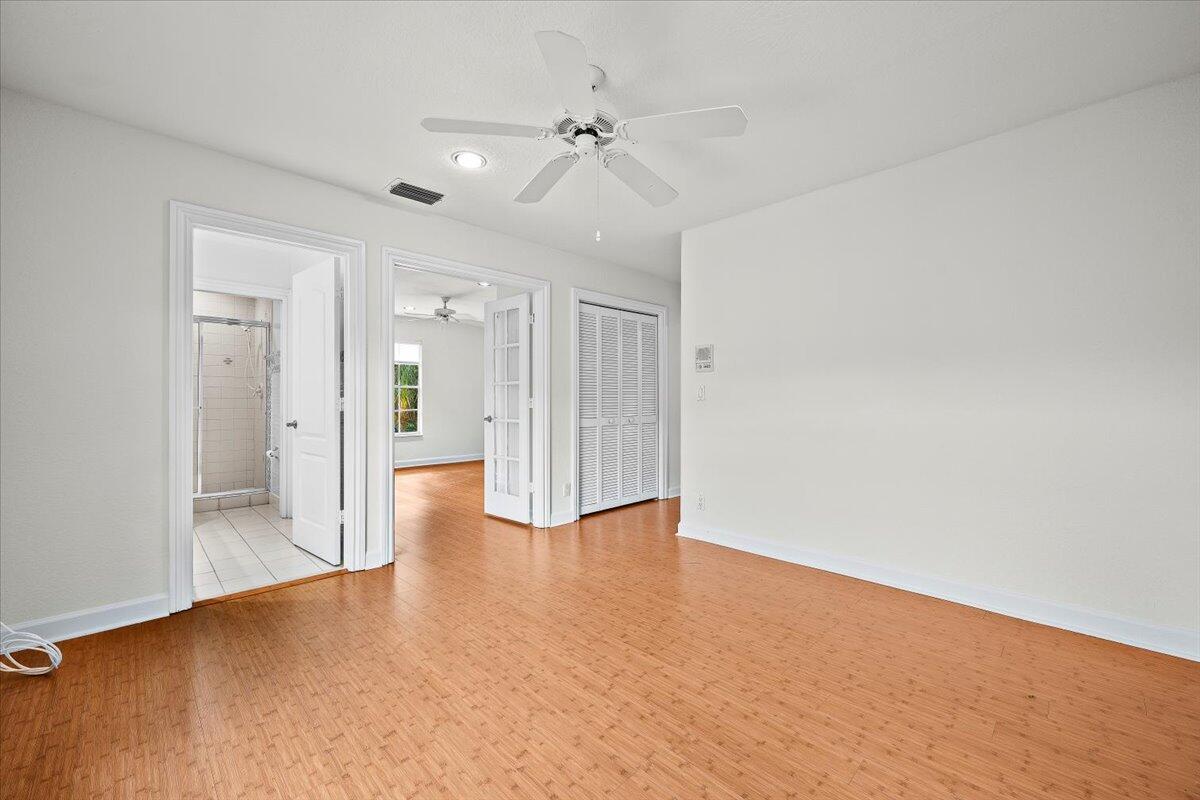 3241 Northwest 63rd Street Boca Raton, FL 33496 - Photo 49 of 75 a view of an empty room with a ceiling fan