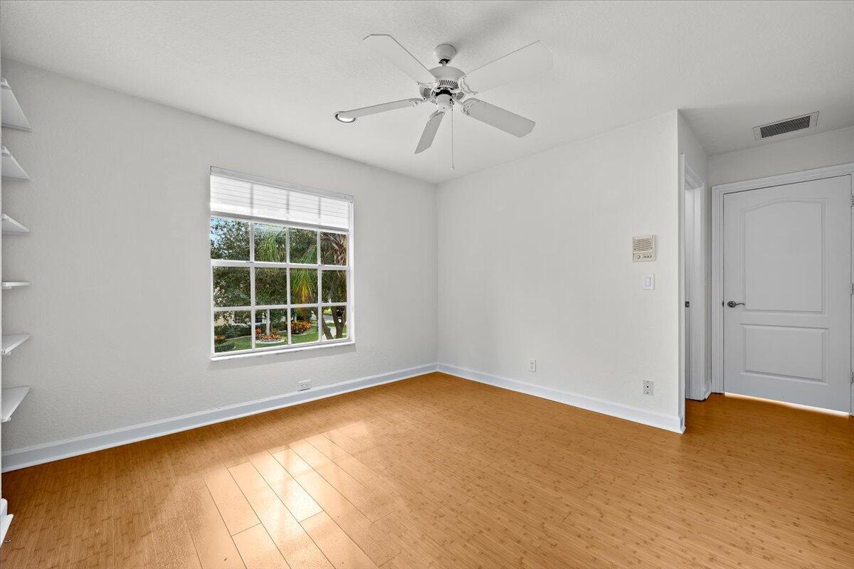3241 Northwest 63rd Street Boca Raton, FL 33496 - Photo 51 of 75 an empty room with a window and ceiling fan