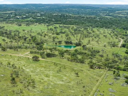 a view of a green field with an ocean view