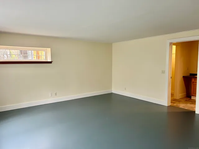 an empty room with a wooden floor and a window