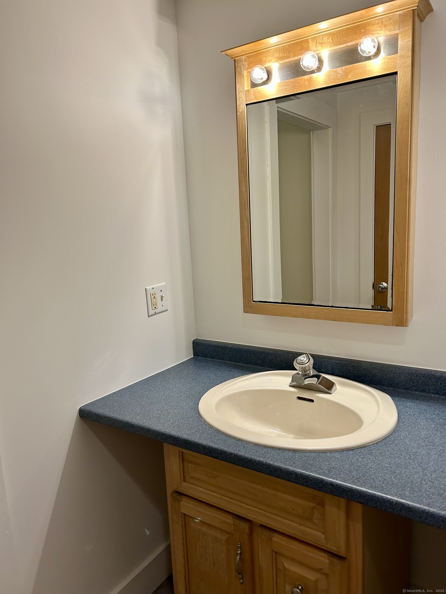 199 Hoop Pole Hill Road Woodbury, CT 06798 - Photo 13 of 15 a bathroom with a sink and a mirror