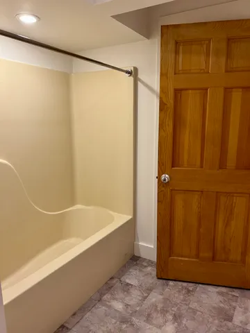 a bathroom with a shower and a bath tub
