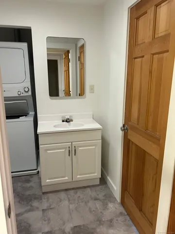 a bathroom with a sink vanity and a mirror
