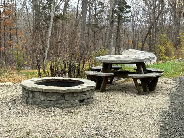 a view of a backyard with table and chairs