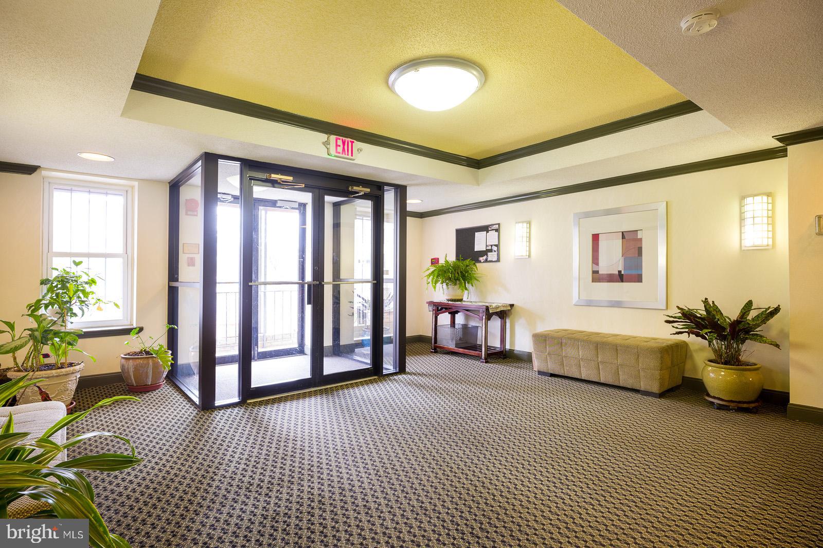 2630 Adams Mill Road Northwest, Unit 105 Washington, DC 20009 - Photo 4 of 13 a lobby with furniture and potted plant