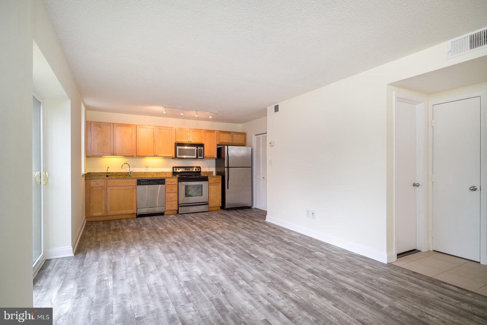2630 Adams Mill Road Northwest, Unit 105 Washington, DC 20009 - Photo 6 of 13 a view of kitchen with wooden floor