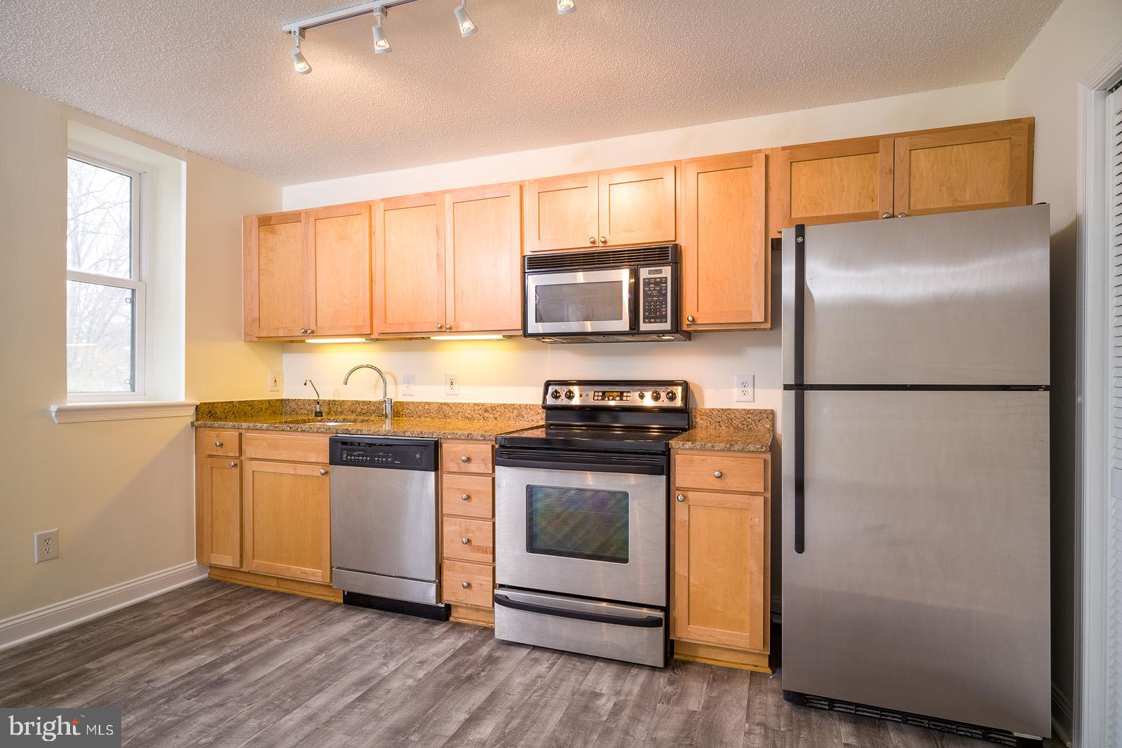 2630 Adams Mill Road Northwest, Unit 105 Washington, DC 20009 - Photo 8 of 13 a kitchen with a refrigerator sink and microwave