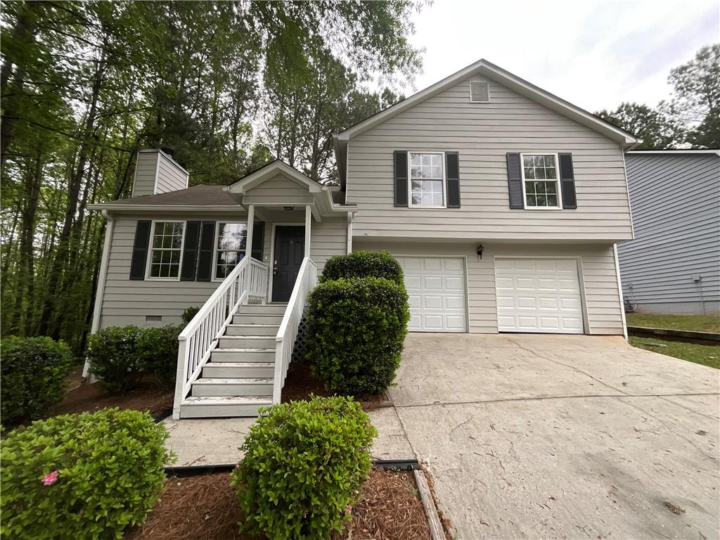 5723 Antelope Trail Atlanta, GA 30349 - Photo 1 of 1 a front view of a house with a garden