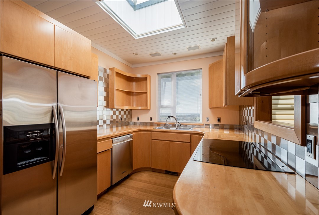 18564 Cascade View Drive Mount Vernon, WA 98274 - Photo 15 of 40 a kitchen with stainless steel appliances granite countertop a sink a stove and a refrigerator