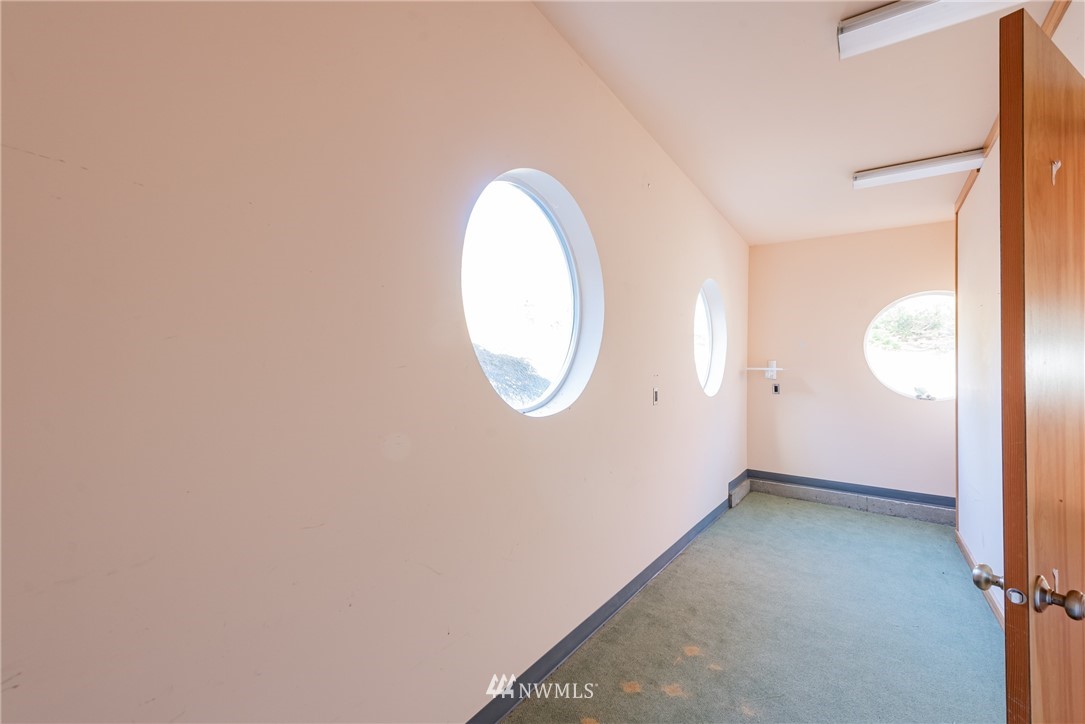 18564 Cascade View Drive Mount Vernon, WA 98274 - Photo 29 of 40 an empty room with wooden floor and windows