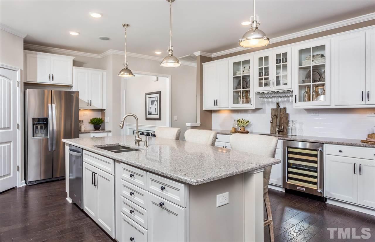 704 Haven Peak Lane Wake Forest, NC 27587 - Photo 12 of 28 a kitchen with a center island appliances and cabinets