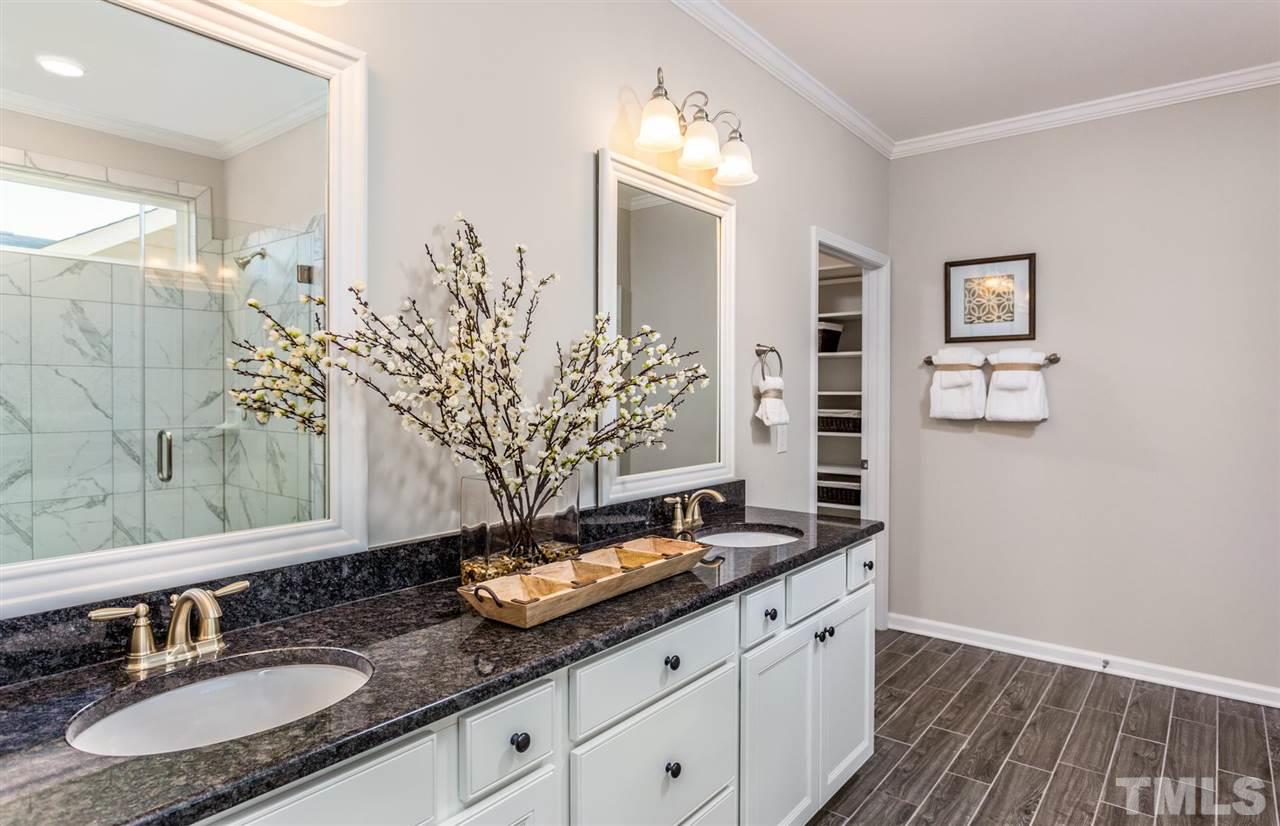 704 Haven Peak Lane Wake Forest, NC 27587 - Photo 17 of 28 a bathroom with a double vanity sink and a mirror