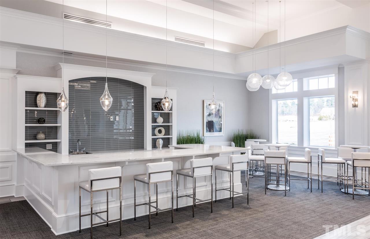 704 Haven Peak Lane Wake Forest, NC 27587 - Photo 22 of 28 a living room with furniture a large window and potted plants
