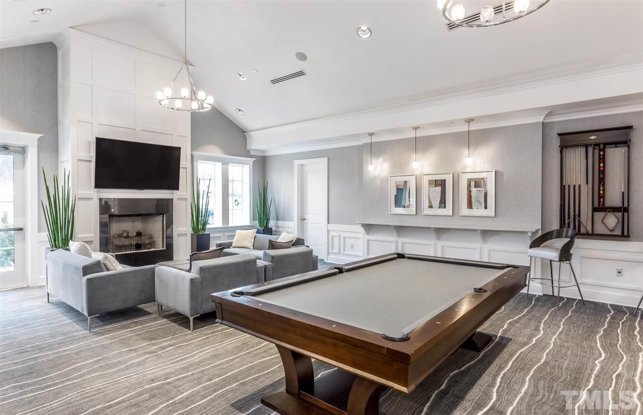 704 Haven Peak Lane Wake Forest, NC 27587 - Photo 23 of 28 a living room with furniture a fireplace and a flat screen tv