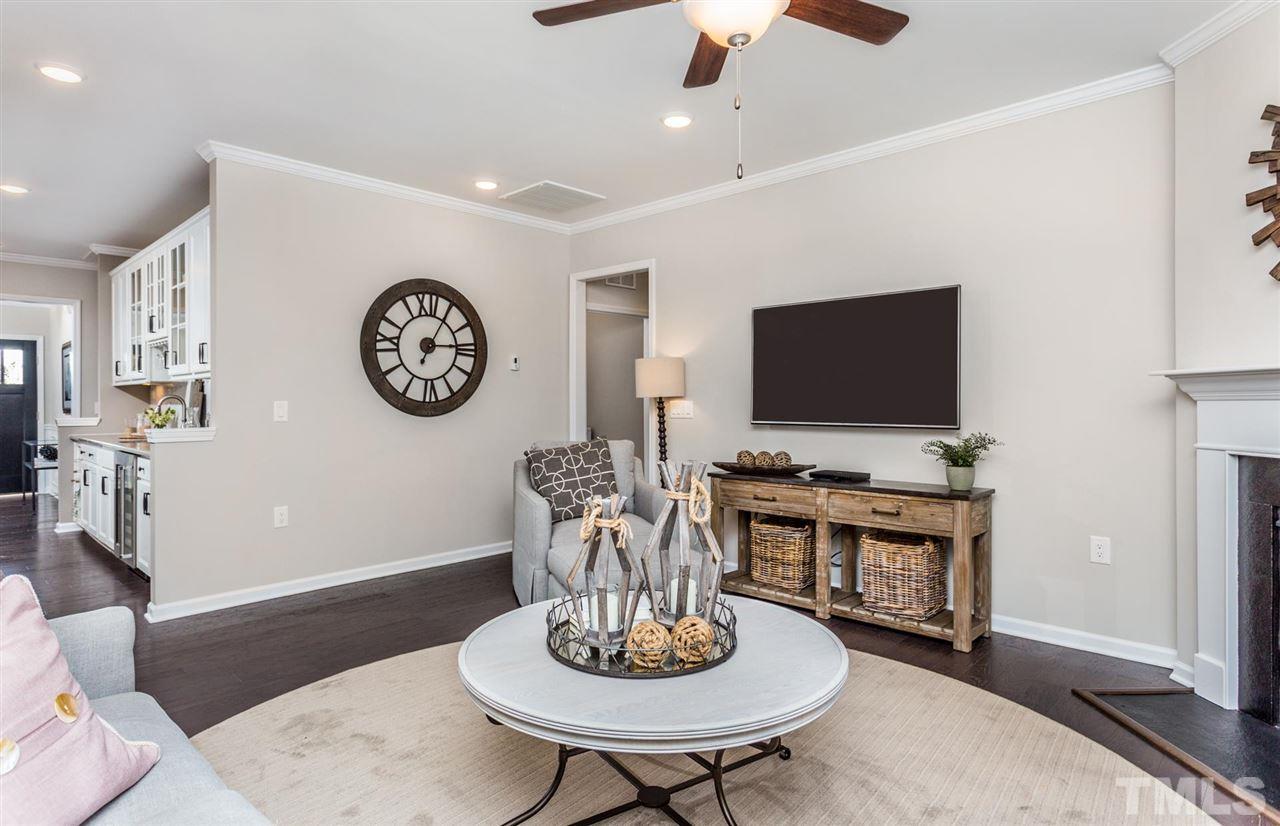 704 Haven Peak Lane Wake Forest, NC 27587 - Photo 8 of 28 a living room with furniture a flat screen tv and a table