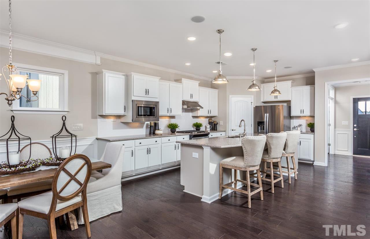 704 Haven Peak Lane Wake Forest, NC 27587 - Photo 10 of 28 a large kitchen with cabinets table and chairs