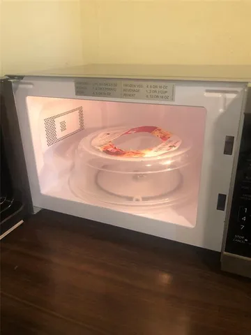 a view of water heater room with wooden floor