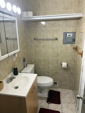 a living room with a fireplace and wooden floor