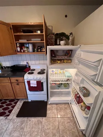 a kitchen with a stove and a refrigerator