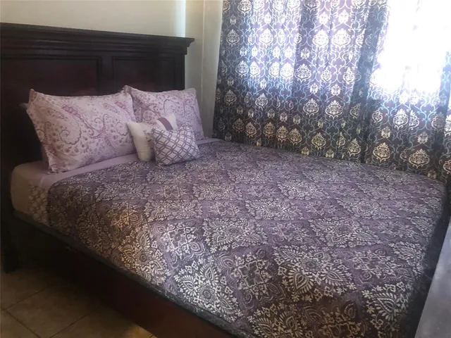 a large bed sitting in the middle of a forest