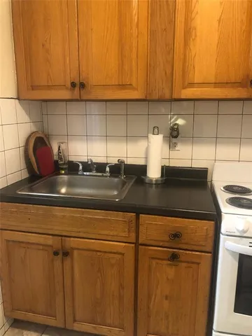 a kitchen with a sink cabinets and a stove top oven