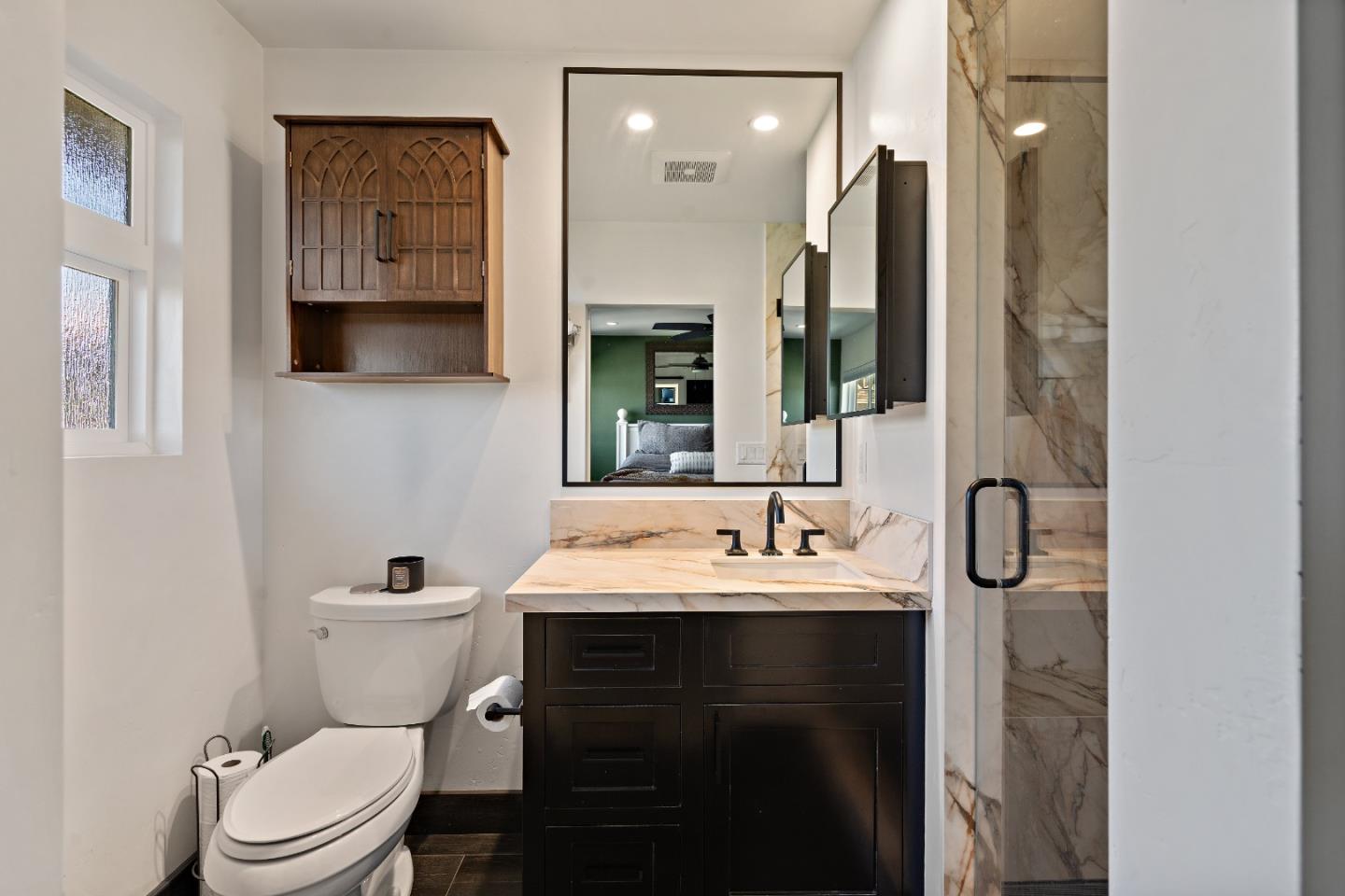 1231 Westward Drive Hollister, CA 95023 - Photo 32 of 68 a bathroom with a toilet sink shower and mirror