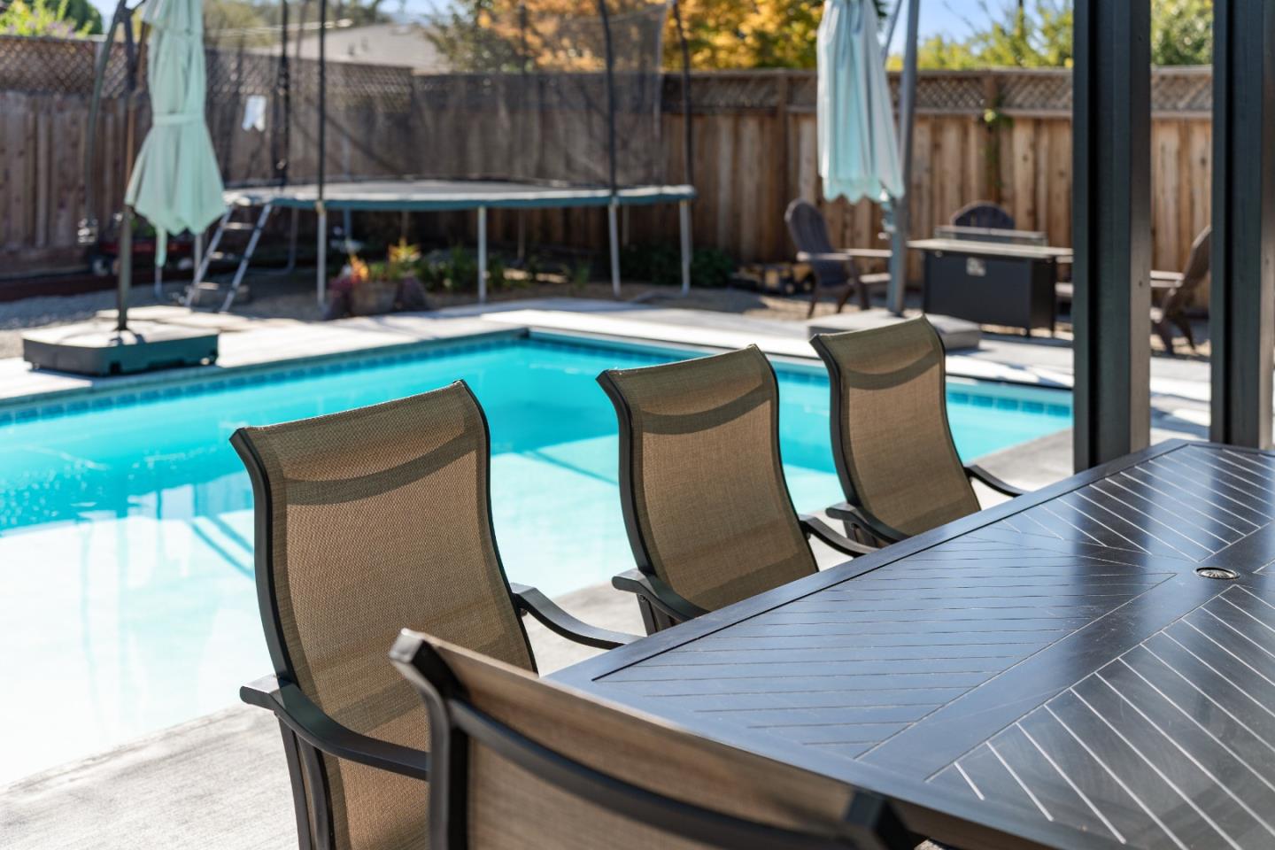 1231 Westward Drive Hollister, CA 95023 - Photo 38 of 68 a view of a patio with table and chairs potted plants and a large tree