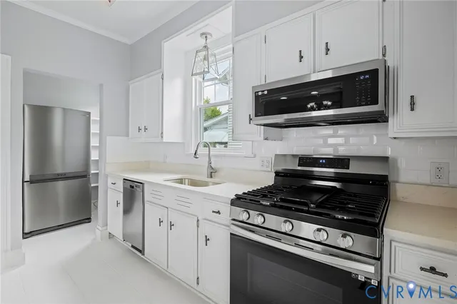 a kitchen with a refrigerator sink and cabinets
