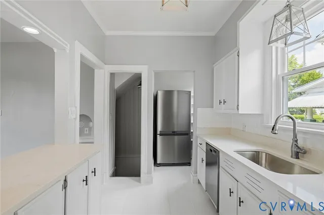 a kitchen that has a sink a stove and window