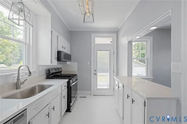 a view of a hallway with wooden floor and stairs