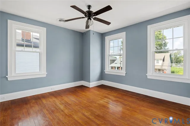 a view of an empty room with wooden floor