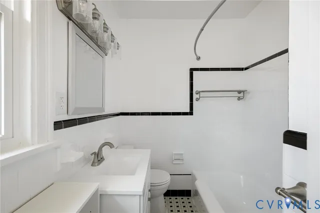 a large white kitchen with stainless steel appliances kitchen island granite countertop a sink and cabinets