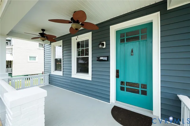 an empty room with wooden floor mirror and windows