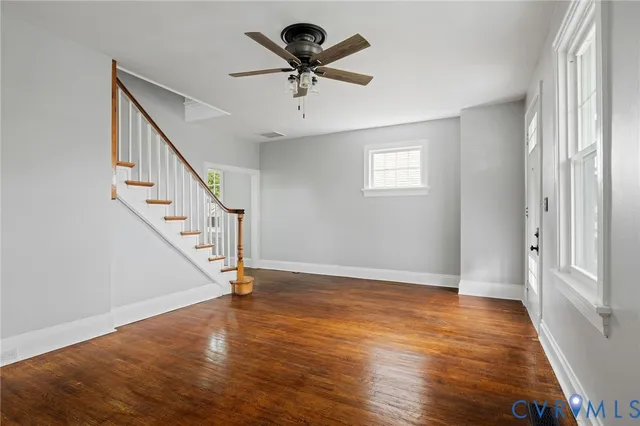 a view of an entryway with wooden floor and windows