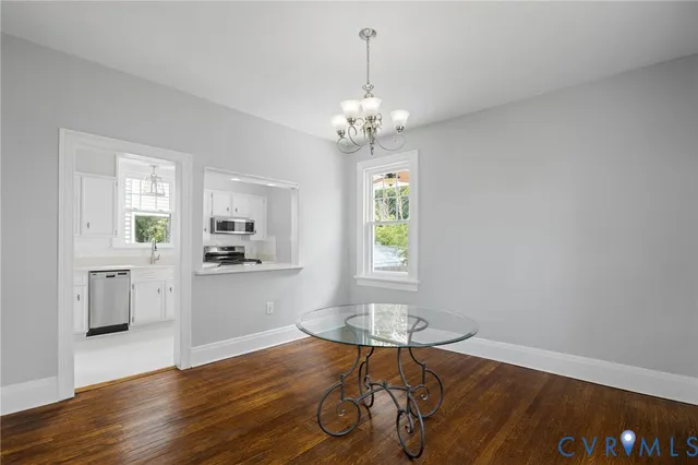 a view of a livingroom with furniture wooden floor and chandelier
