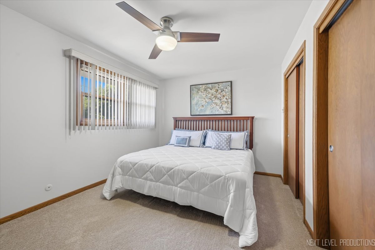 754 North Michigan Street Elmhurst, IL 60126 - Photo 17 of 32 a spacious bedroom with a bed and a window