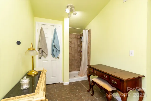 a spacious bedroom with a bed and a dresser