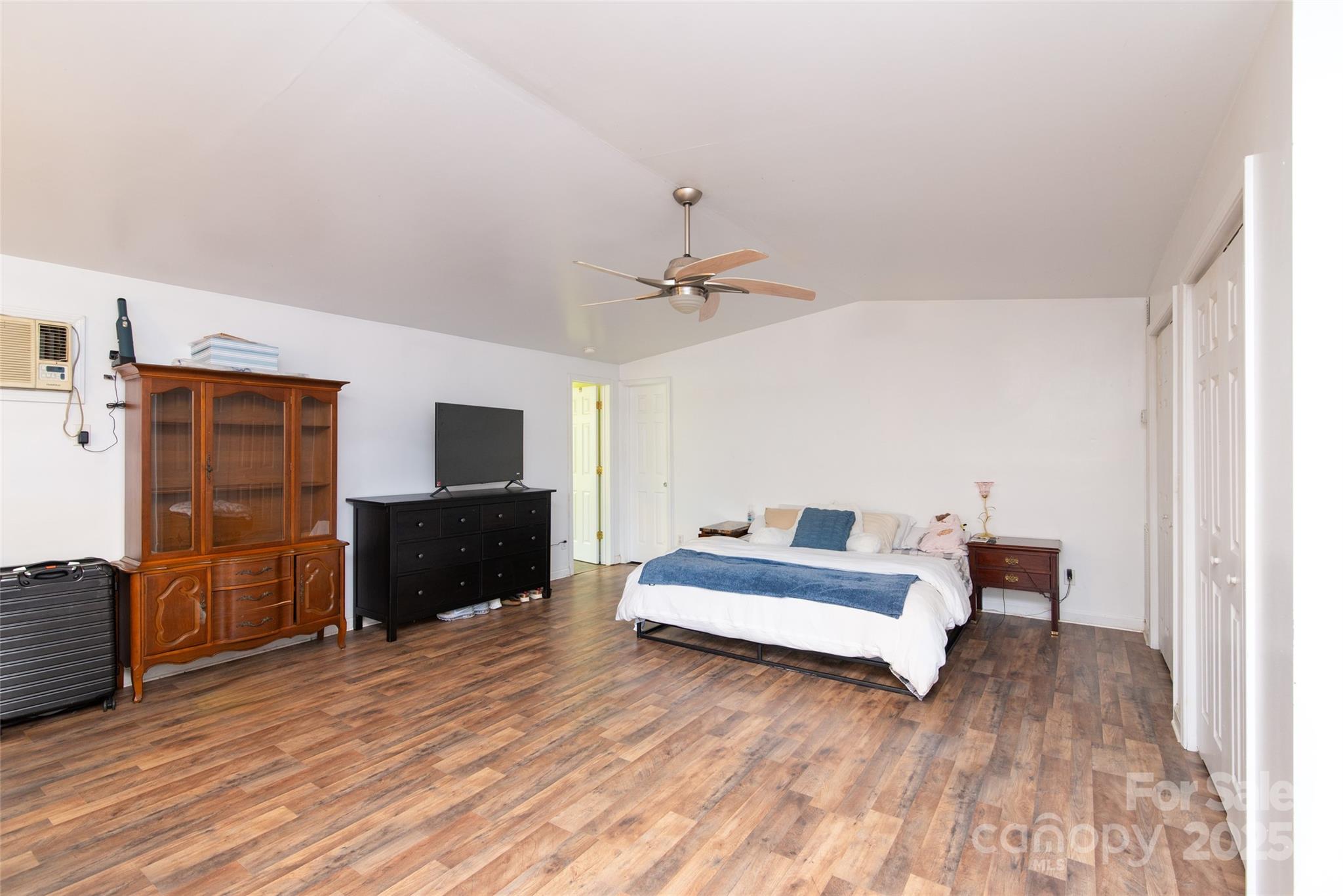 1137 Saunders Road Franklin, NC 28734 - Photo 19 of 30 a spacious bedroom with a bed and a dresser