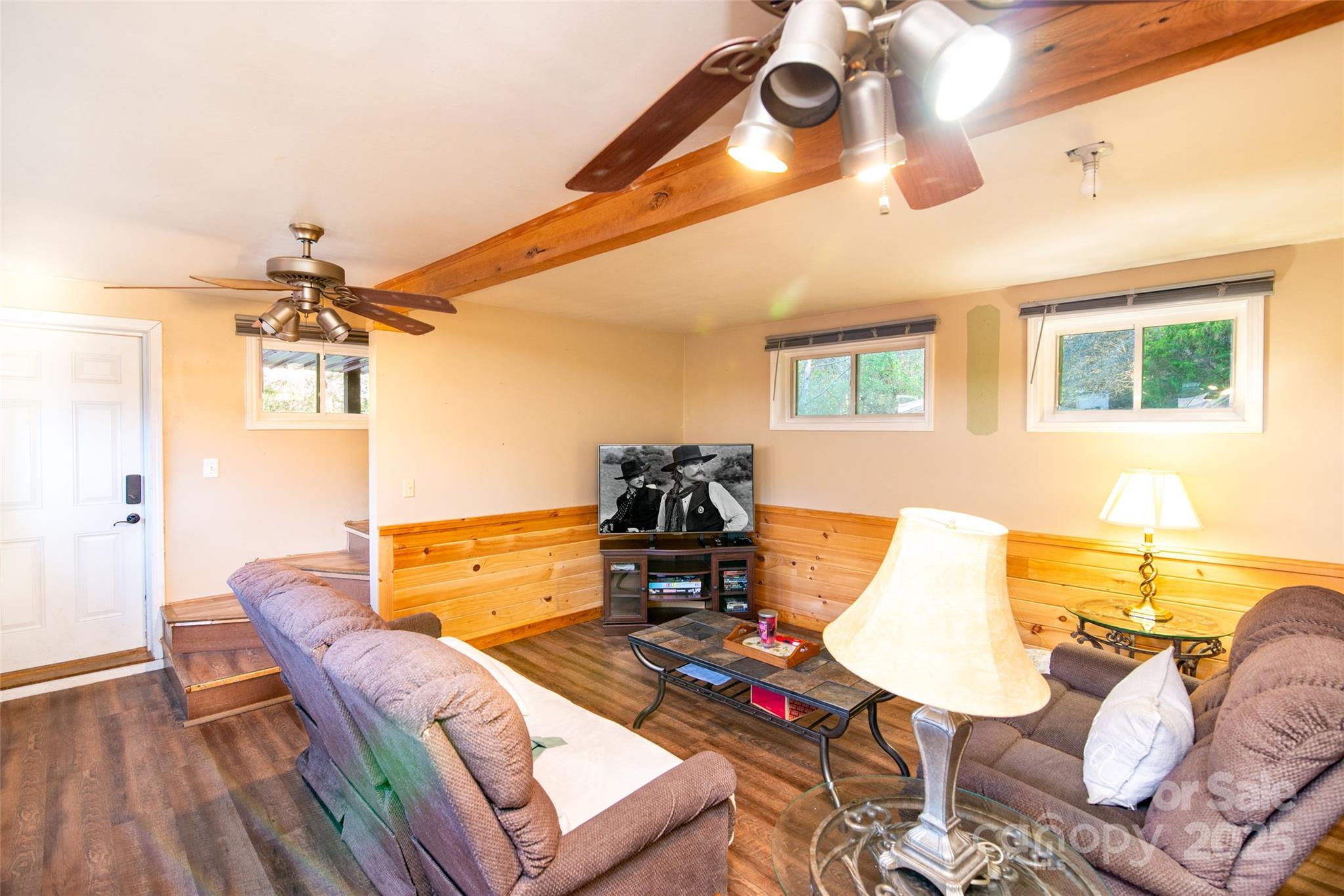 1137 Saunders Road Franklin, NC 28734 - Photo 29 of 30 a living room with furniture and a flat screen tv with wooden floor